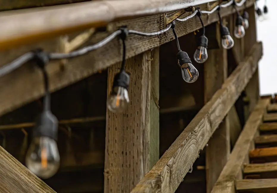 Close-up of rustic wooden structure with string lights, creating a warm ambiance.