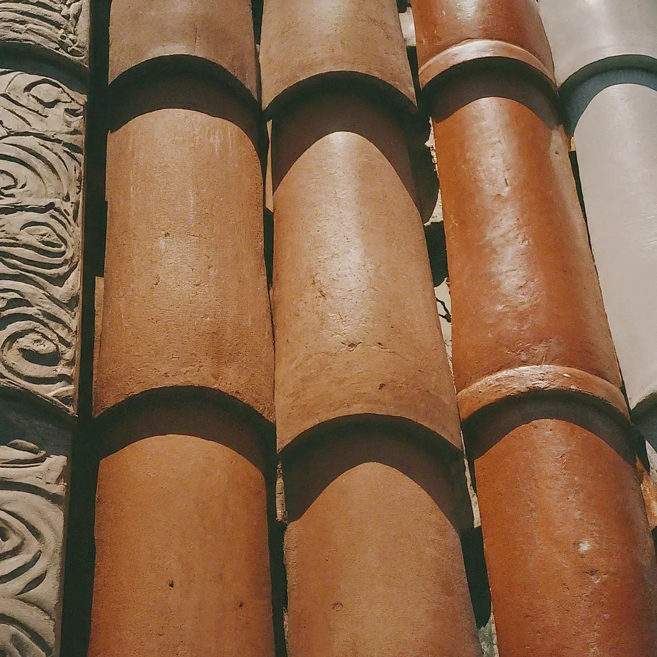 Close-up of rustic tiles with varying textures and colors. 35mm stock photo