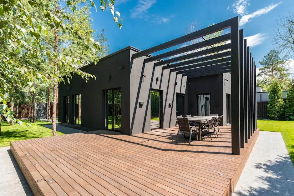 Stylish outdoor space with wooden deck and dining set, surrounded by lush greenery.