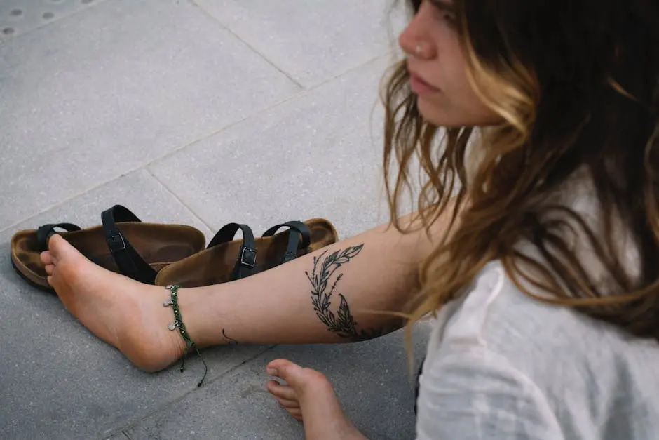 Woman Sitting on a Pavement with Her Shoes Off