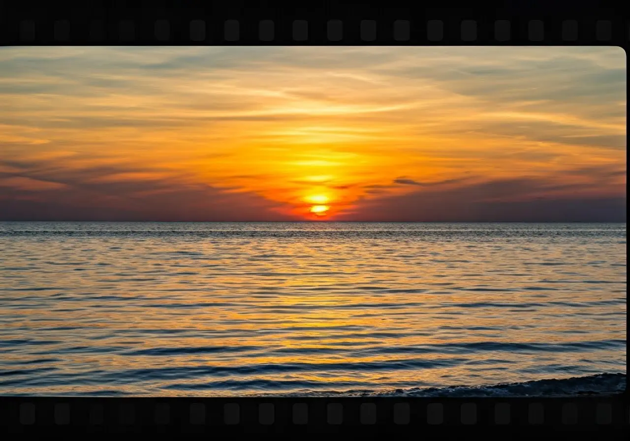 A serene sunset over a calm ocean horizon. 35mm stock photo