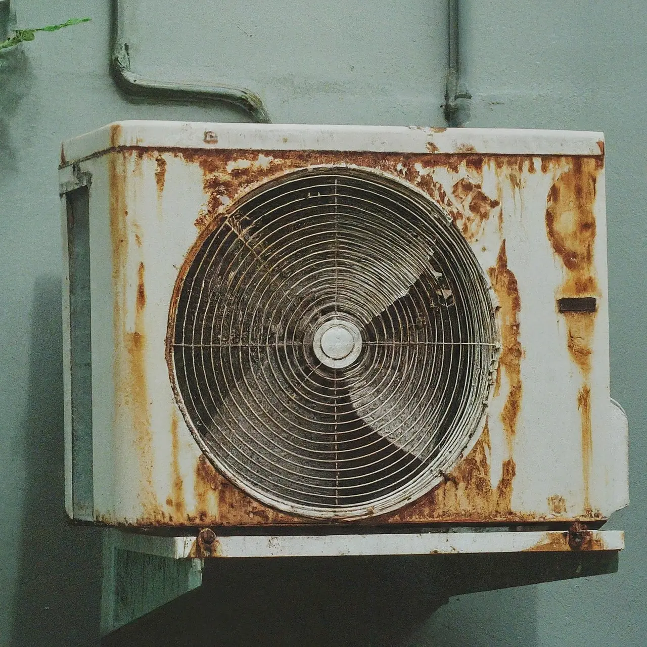 An old air conditioning unit with rust and wear marks. 35mm stock photo