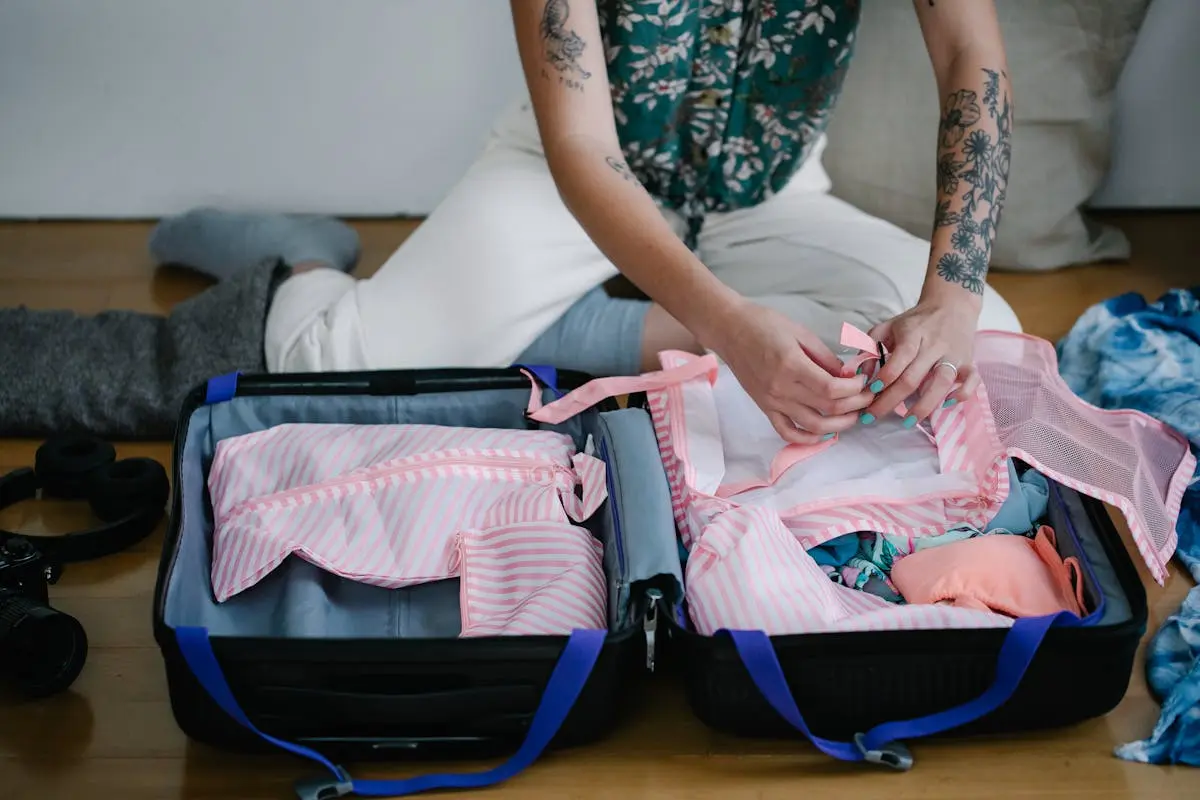 A Person Packing Up things in packing cubes