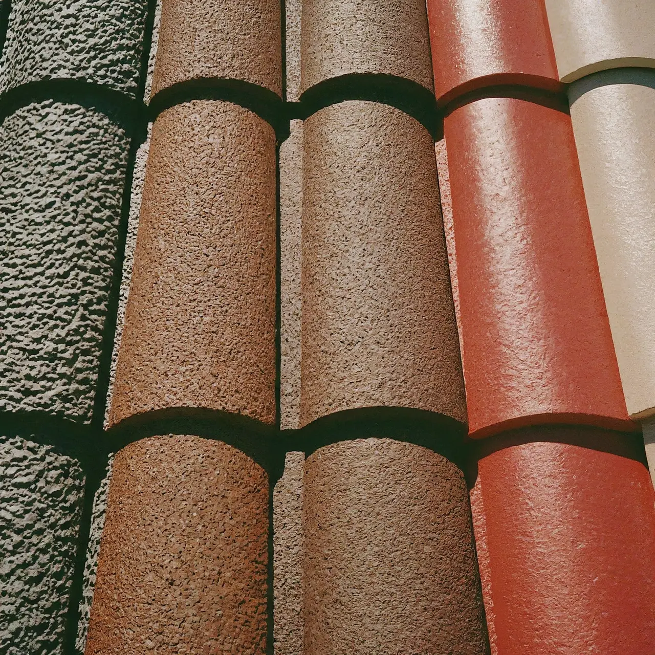 Close-up of different roofing shingles with varying colors and textures. 35mm stock photo