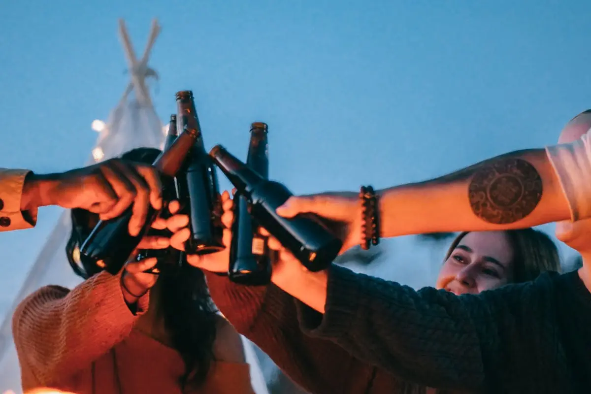 Group of Friends Clinking Beer Bottles