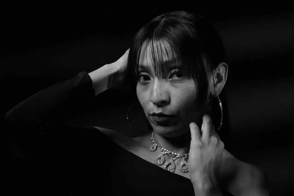 Stunning monochrome portrait of a woman with jewelry and hoop earrings.