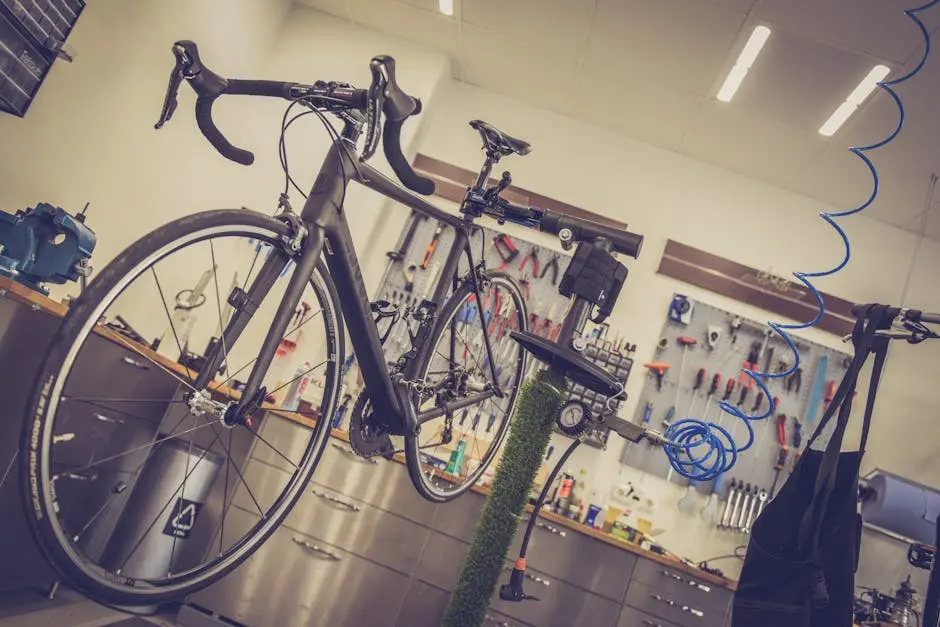 Detailed view of a bicycle being repaired in a modern workshop with tools and equipment.