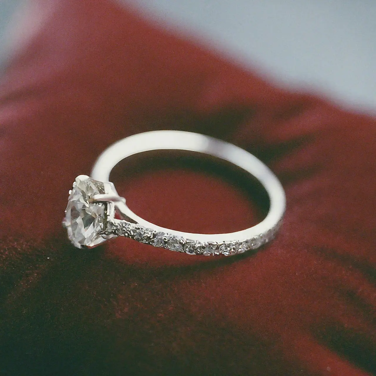 An elegant oval diamond ring on a velvet cushion. 35mm stock photo