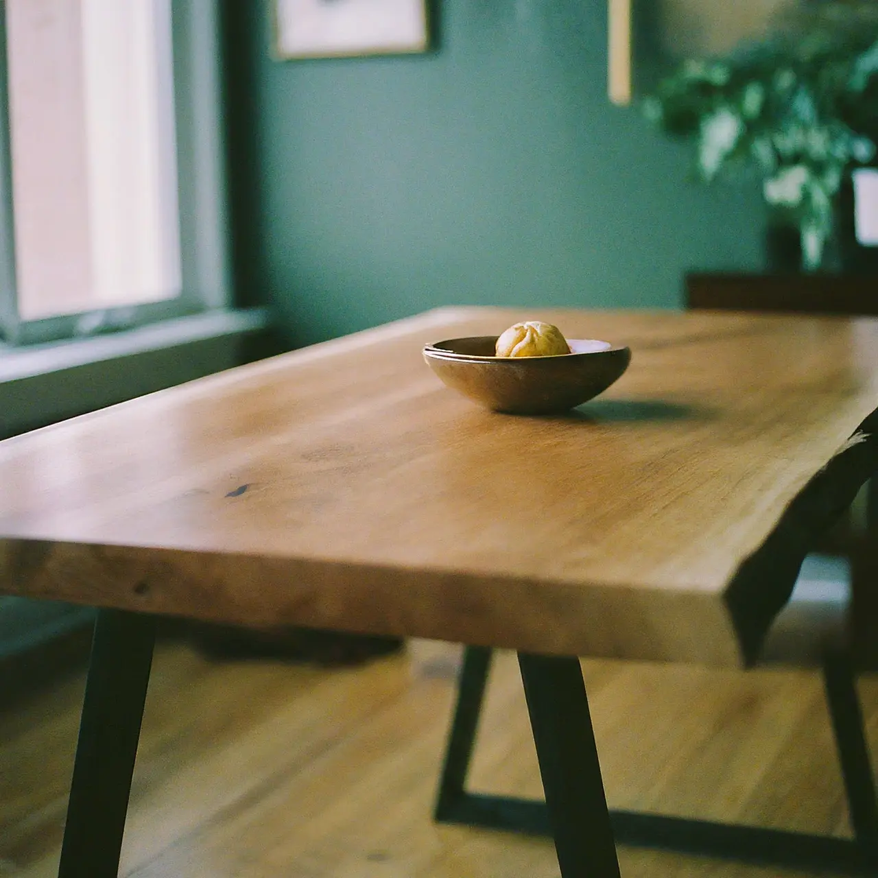 A live edge wooden table in an urban home setting. 35mm stock photo