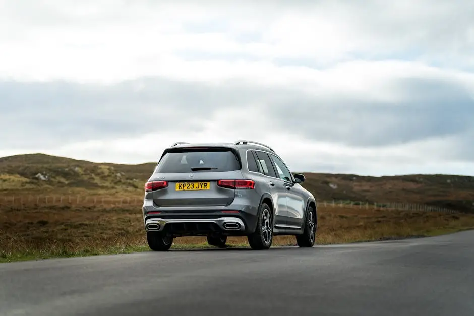 Modern SUV driving on a scenic countryside road during daytime.