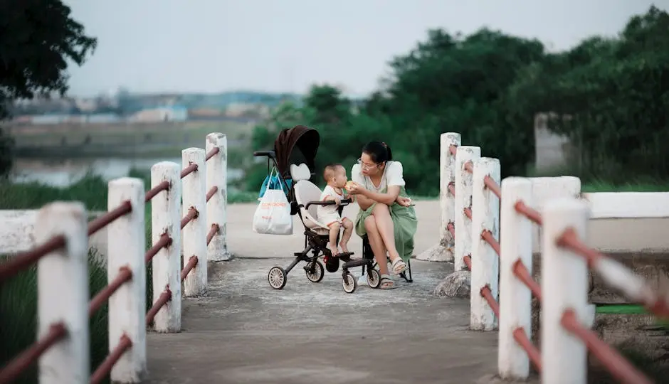 Mother Sitting with Son on Stroller and Feeding