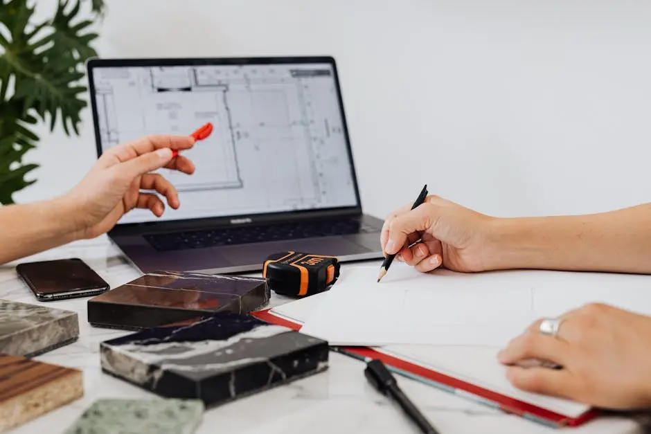 A Person Using a Pencil near Tile Samples