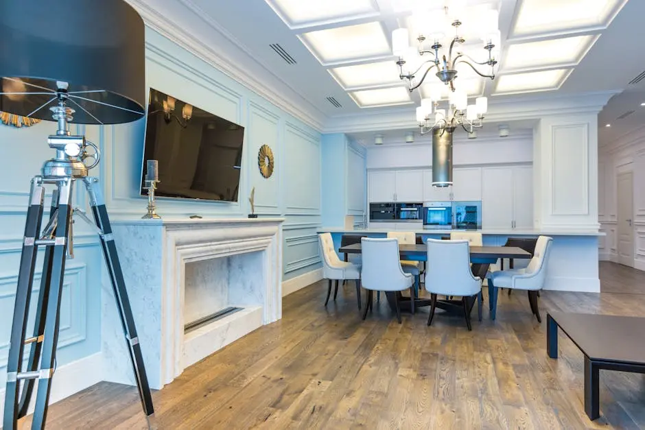 Spacious interior dining room featuring a chic chandelier, wooden floor, and marble fireplace.