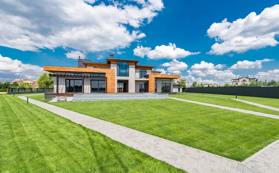 Picturesque landscape of villas with green lawn and cobblestone paths on background of cloudy blue sky