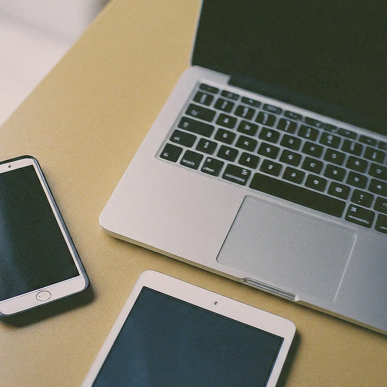 Laptop, smartphone, and digital tablet on an office desk. 35mm stock photo