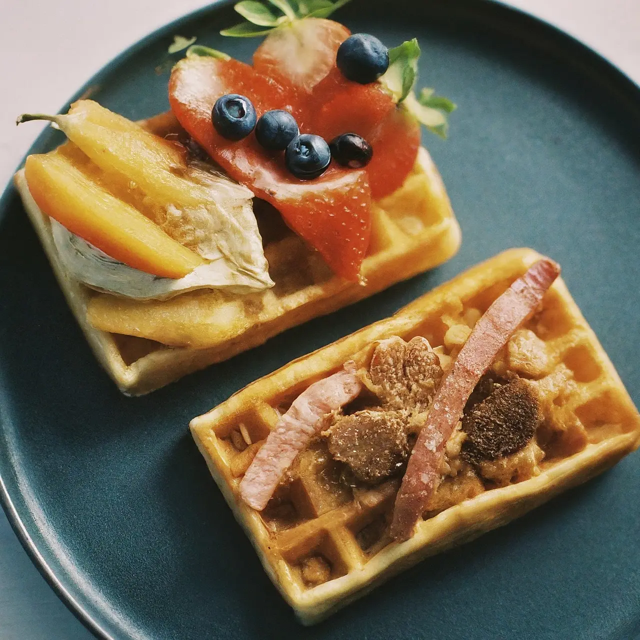 Close-up of sweet and savory waffles with unique toppings. 35mm stock photo