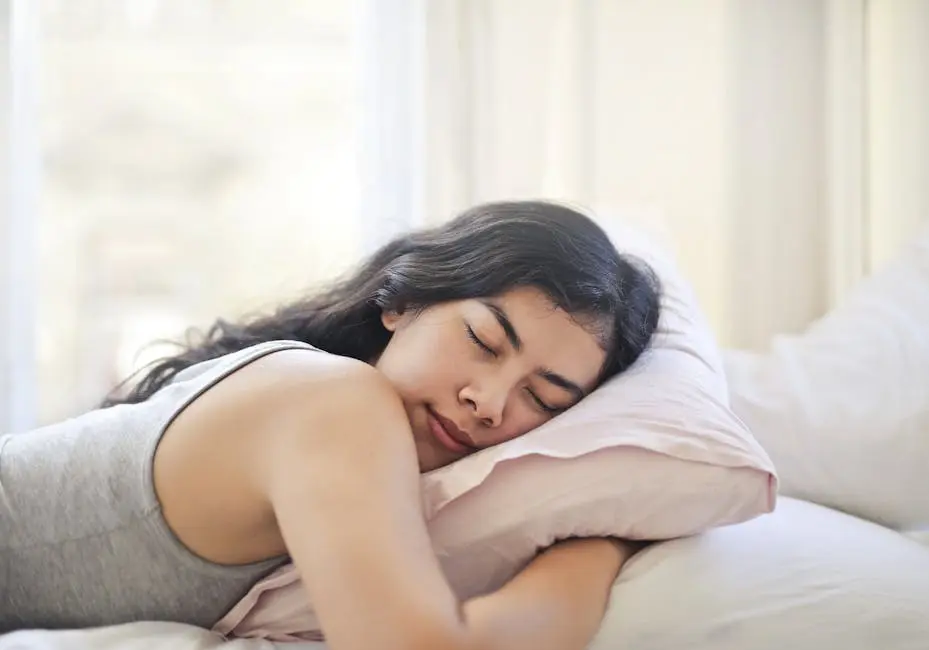 Serene woman resting on a comfortable bed with soft pillows and natural light.