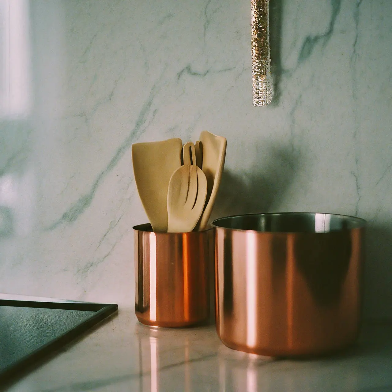 Modern kitchen with neatly arranged cookware on a marble countertop. 35mm stock photo