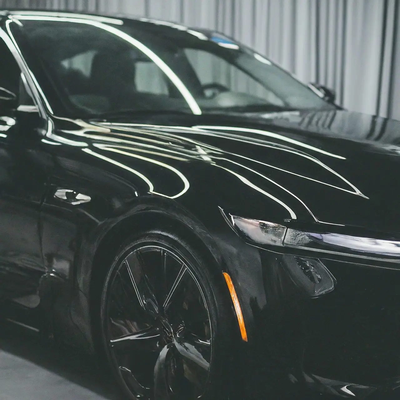 A shiny car with half ceramic coated and half traditional waxed. 35mm stock photo