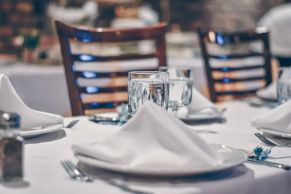 Sophisticated restaurant table setting with crystal glassware and white napkins, perfect for fine dining experiences.