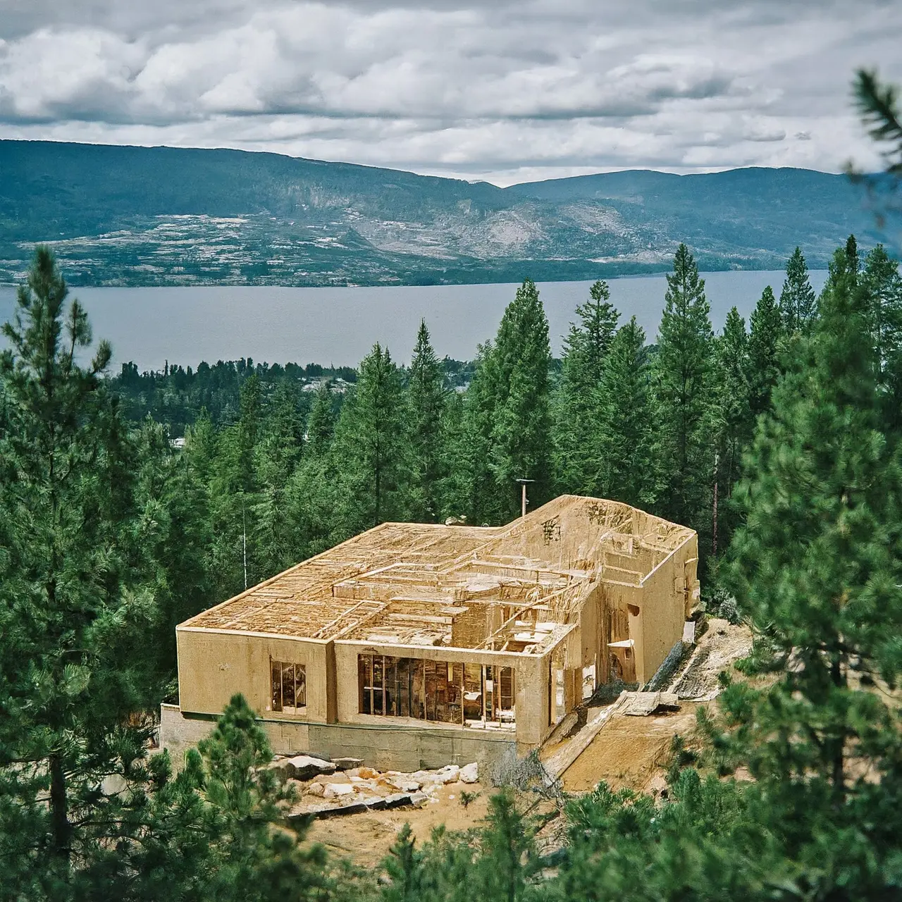 Modern house construction in Kelowna with scenic backdrop. 35mm stock photo