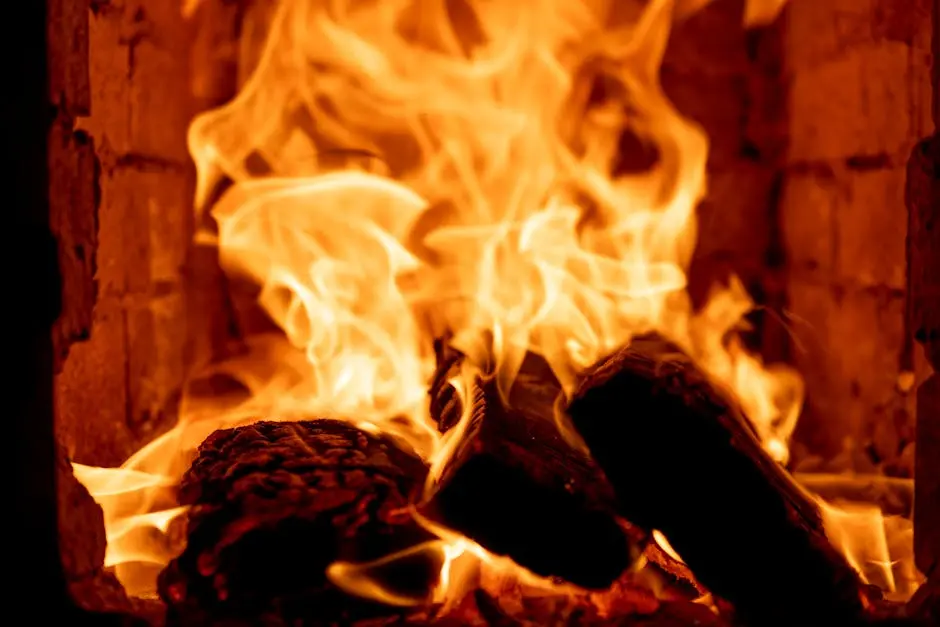 A close-up shot of vibrant flames enveloping firewood in a brick fireplace.