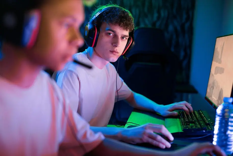 Two young men focused on a competitive gaming session, showcasing teamwork and strategy.