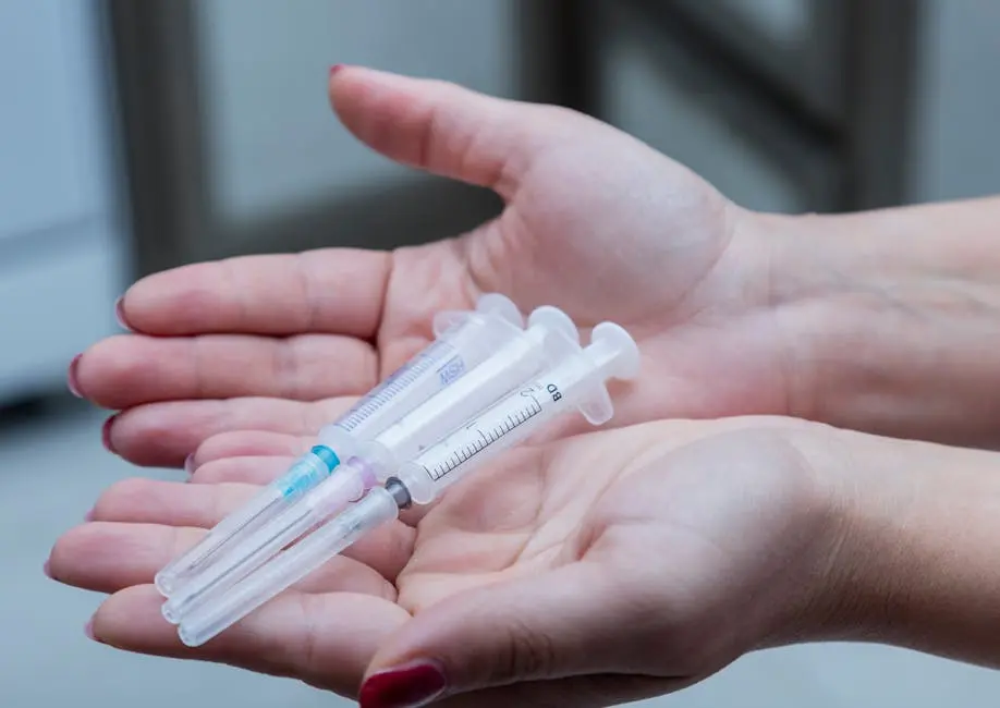 A Person Holding Plastic Syringes