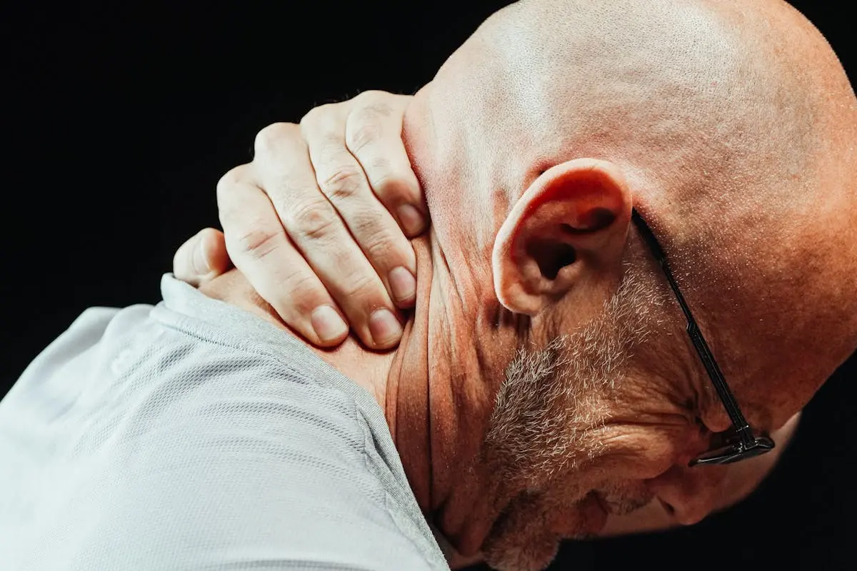 Close-Up Photo of a Man Having a Neck Pain