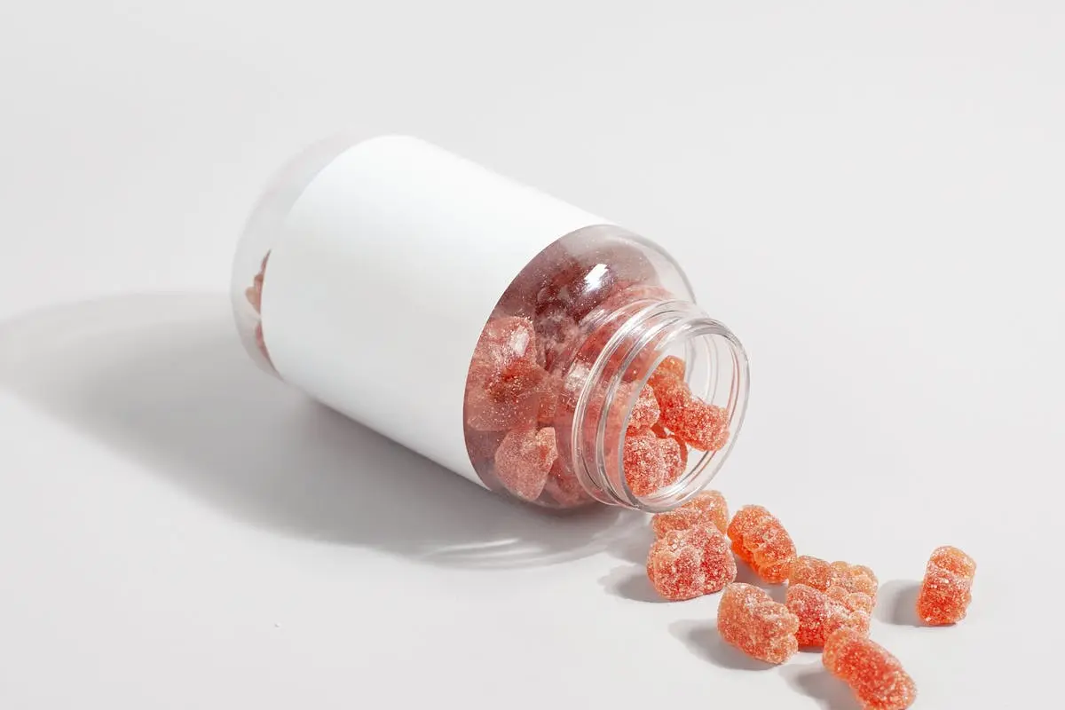 Close-Up Shot of Supplement Gummies on White Surface