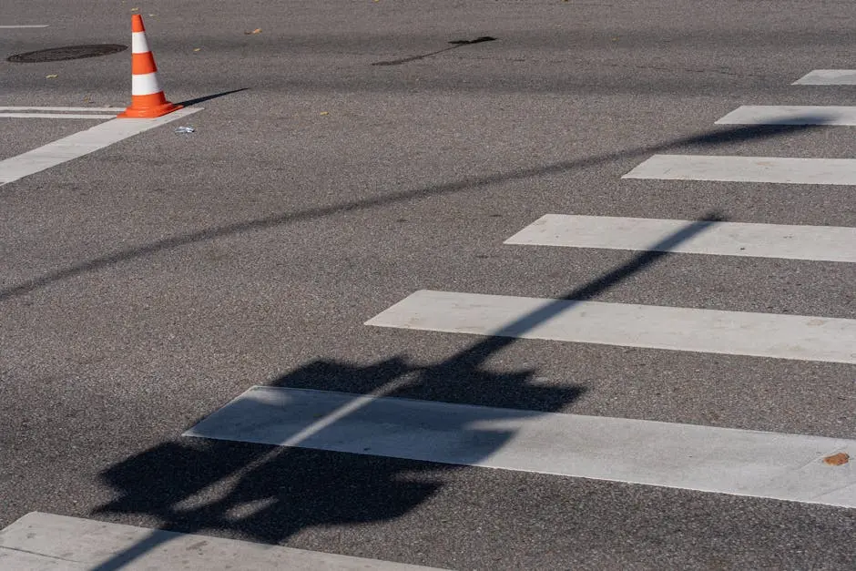 A street with a crosswalk and traffic cones