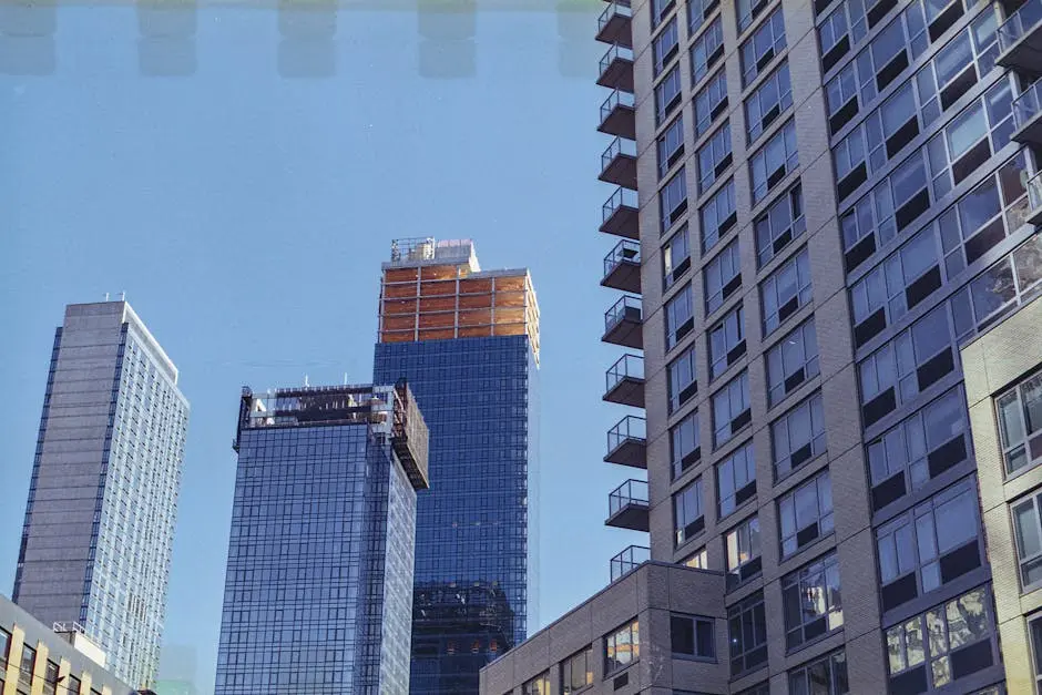 A vibrant cityscape of modern skyscrapers under a clear blue sky in New York City, USA.