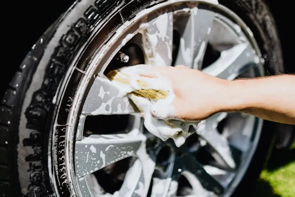 A Person Cleaning a Rim of a Car