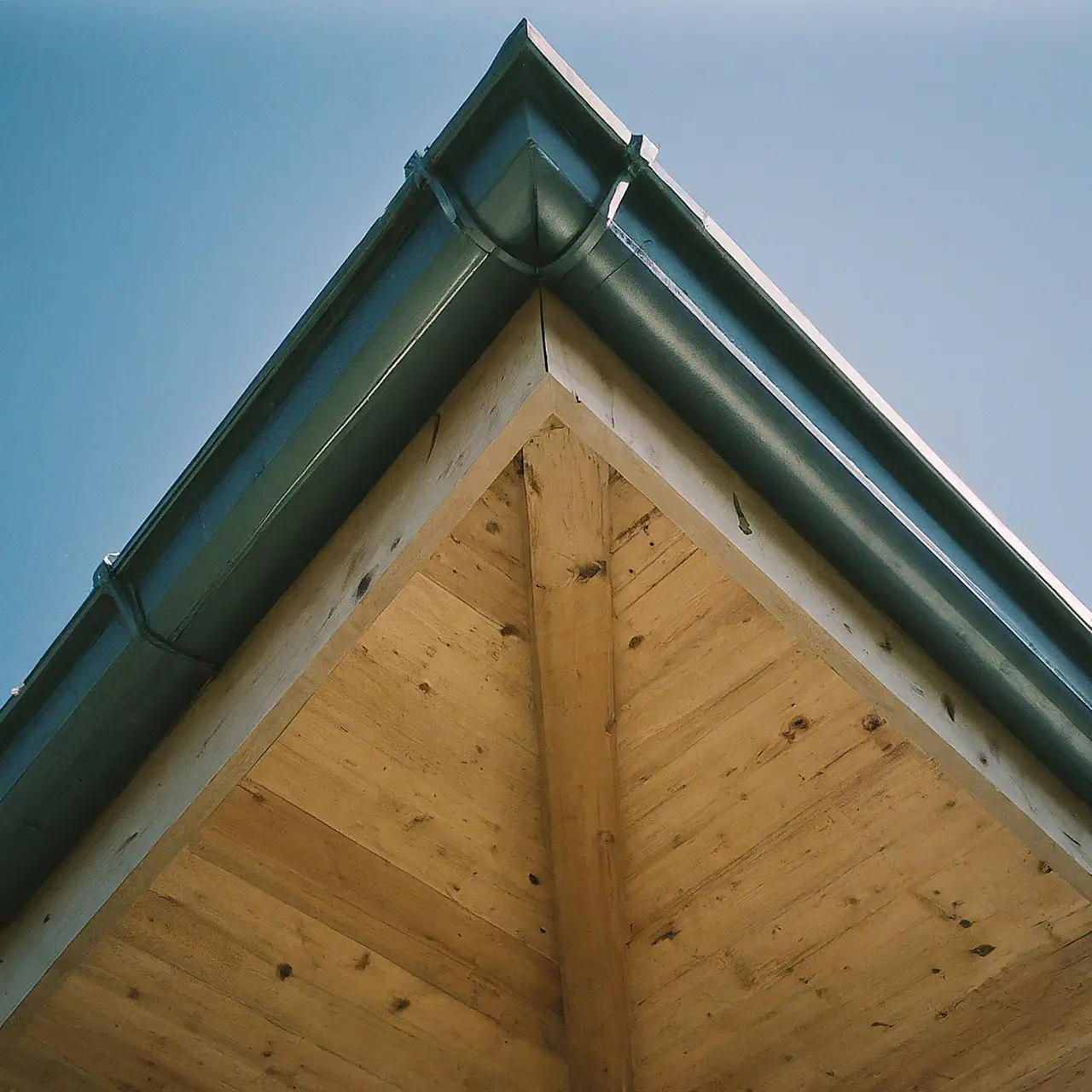 A well-sealed roof under a clear, blue sky. 35mm stock photo