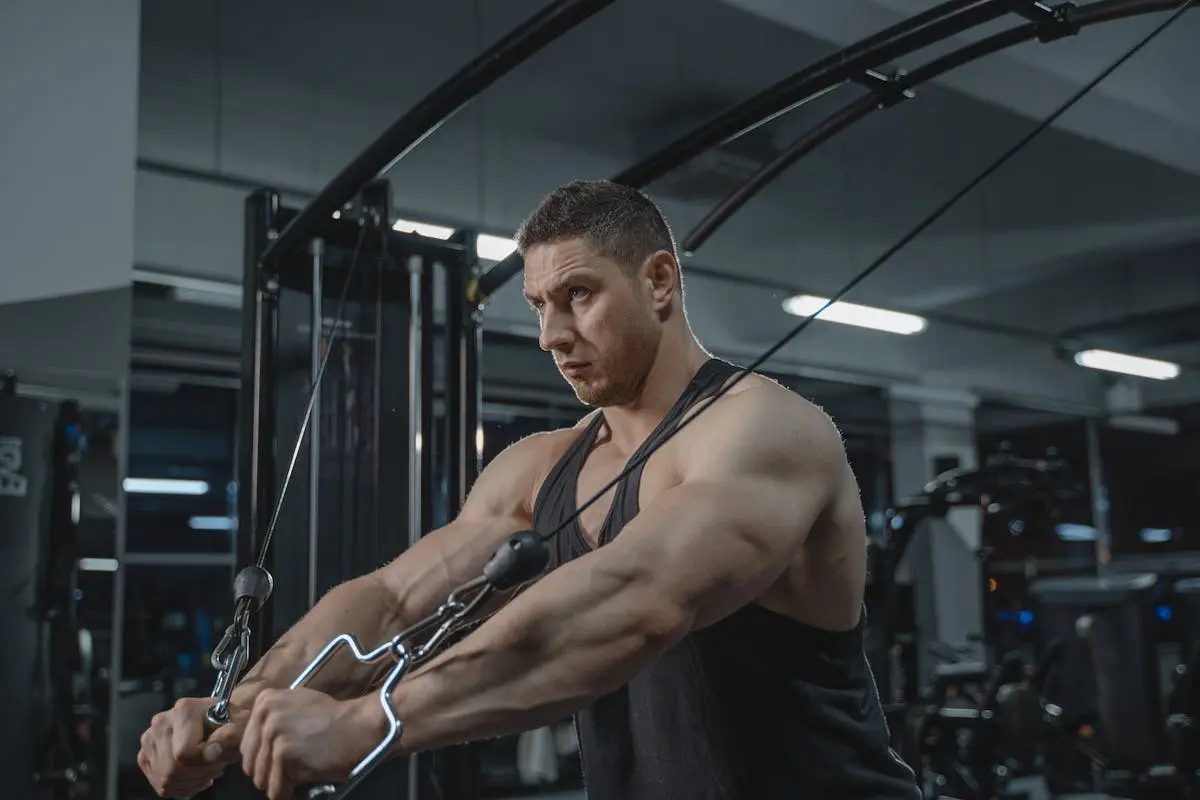 A Man Working Out Using the Cable Crossover Machine