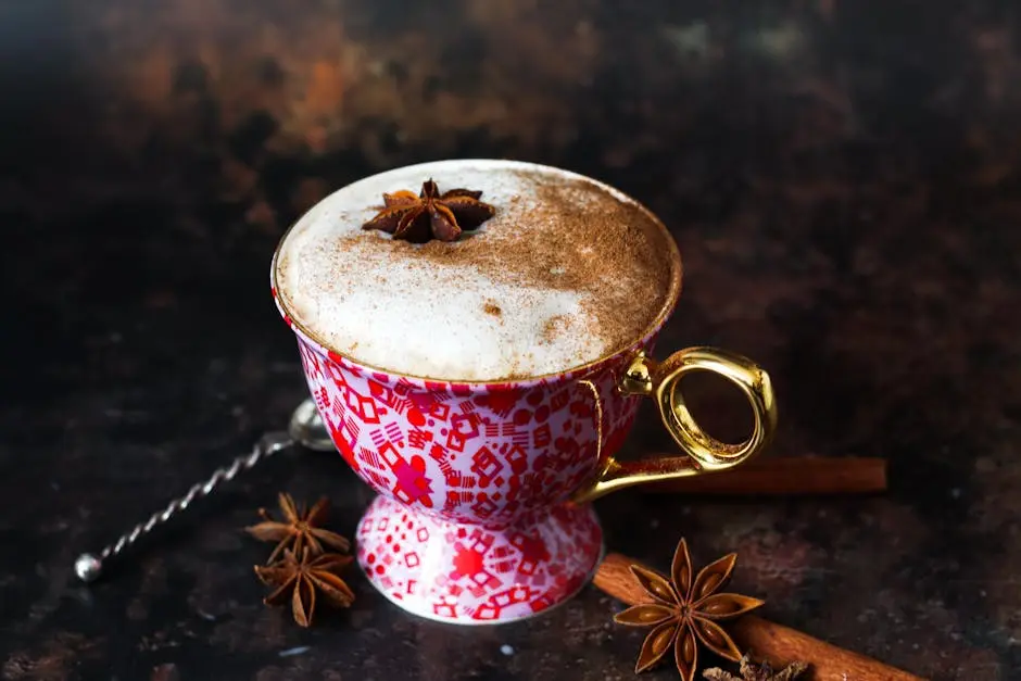 Aesthetic close-up of a spiced latte with cinnamon and star anise in a patterned cup, perfect for cozy moments.