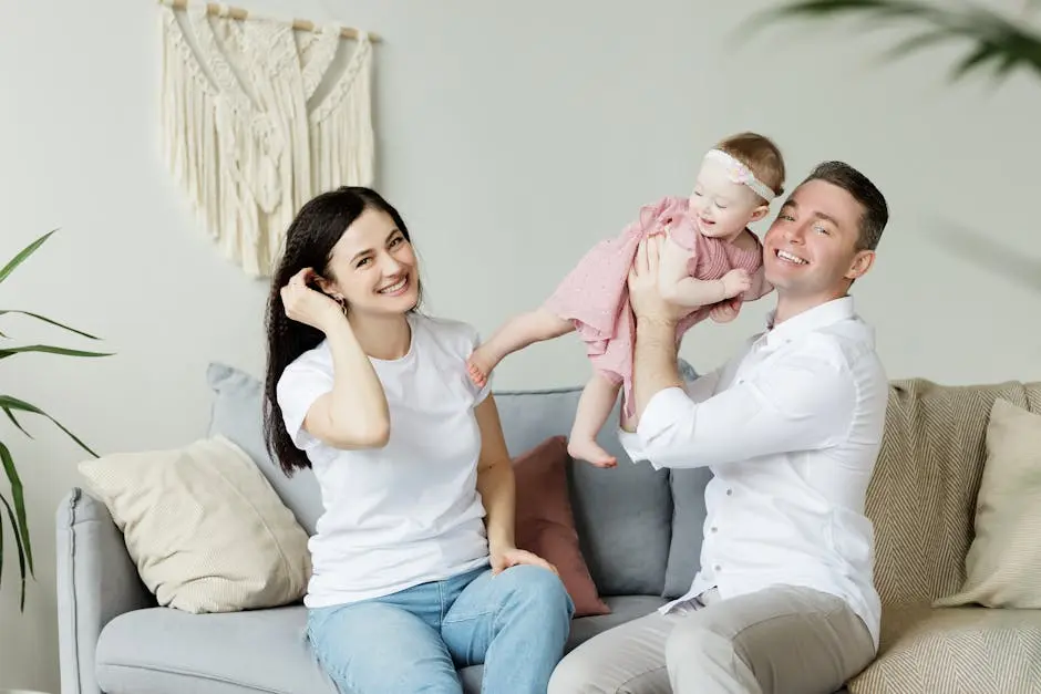 Loving parents playing with their baby daughter at home, capturing moments of joy and togetherness indoors.