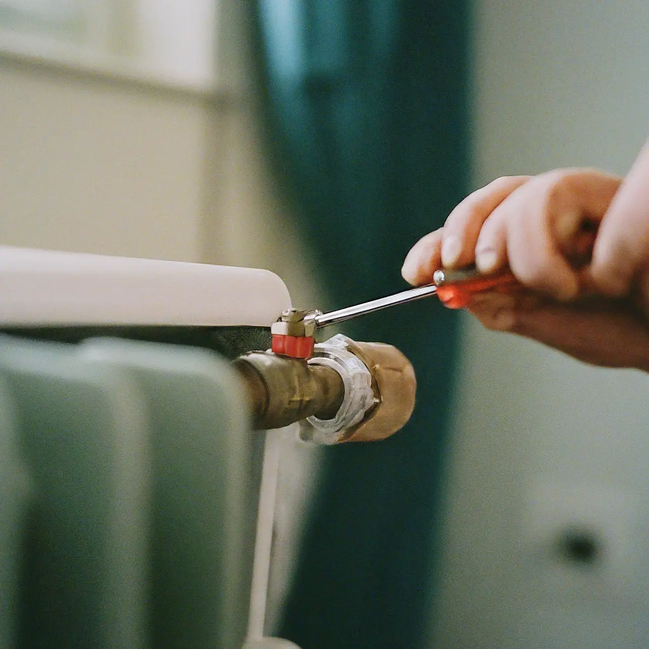 A technician repairing a residential heating unit. 35mm stock photo