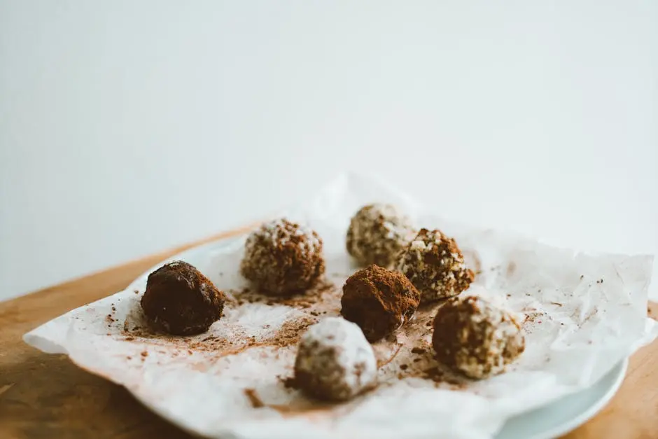 Chocolate Balls on Baking Paper on White Ceramic Plate