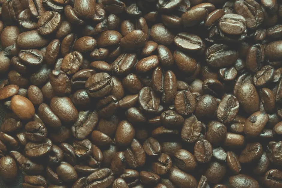 Detailed macro shot of roasted Arabica coffee beans, showcasing texture and rich brown color.