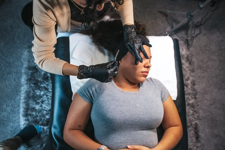 Esthetician performing a facial treatment on a woman in a spa setting, emphasizing skincare.