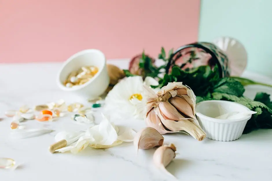 Flat lay of garlic, supplements, and herbs showcasing natural remedies on a marble surface.