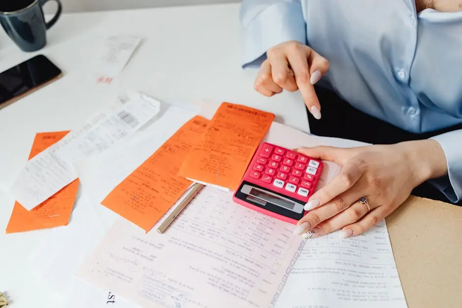 Businesswoman calculates expenses using receipts and calculator at desk. Ideal for finance, accounting themes.