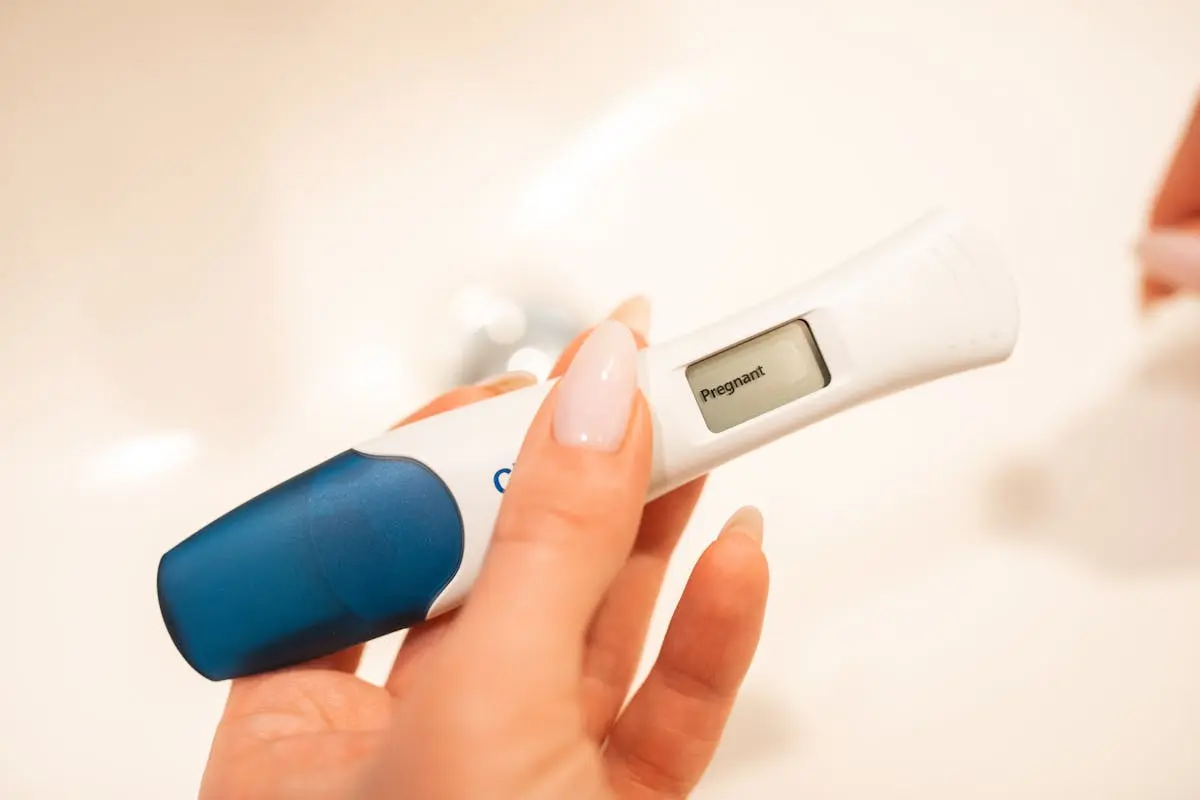 A Woman Hand Holding a Digital Pregnancy  Test Kit