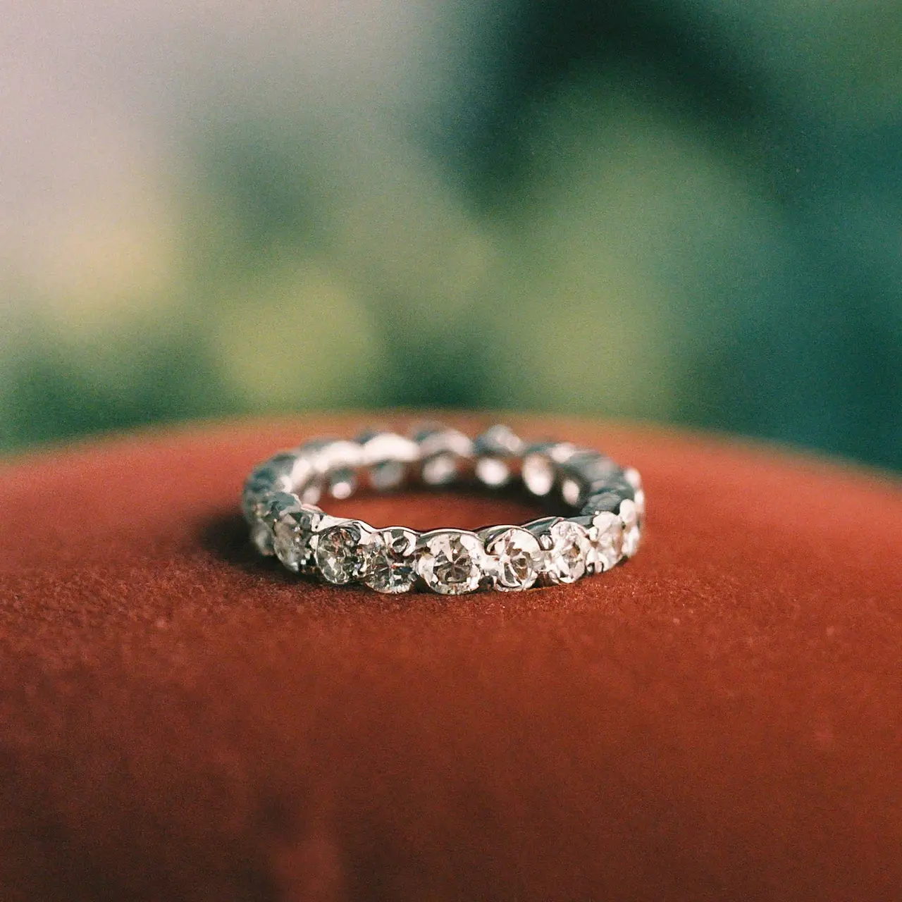 A close-up of a diamond eternity band on a velvet cushion. 35mm stock photo