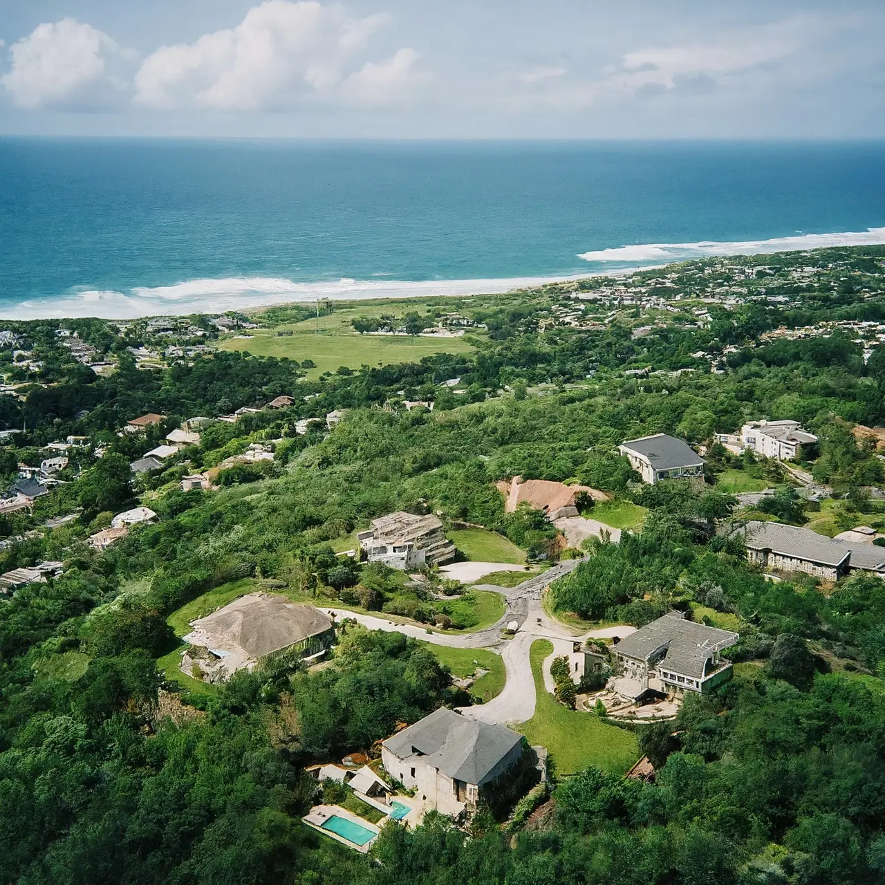 Aerial view of picturesque coastline estates with ocean backdrop. 35mm stock photo