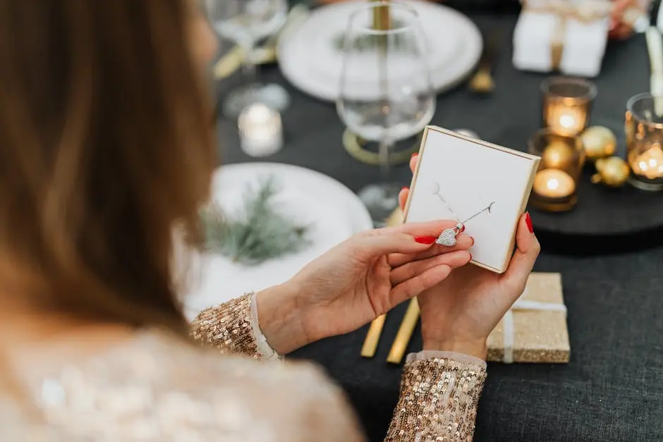 A woman opens a necklace gift surrounded by a festive dinner setting, creating a warm, celebratory mood.