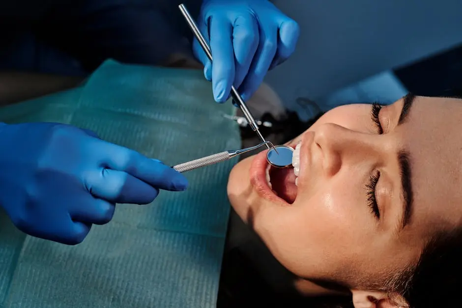 Close-up of a dentist examining a patient’s teeth using dental tools.