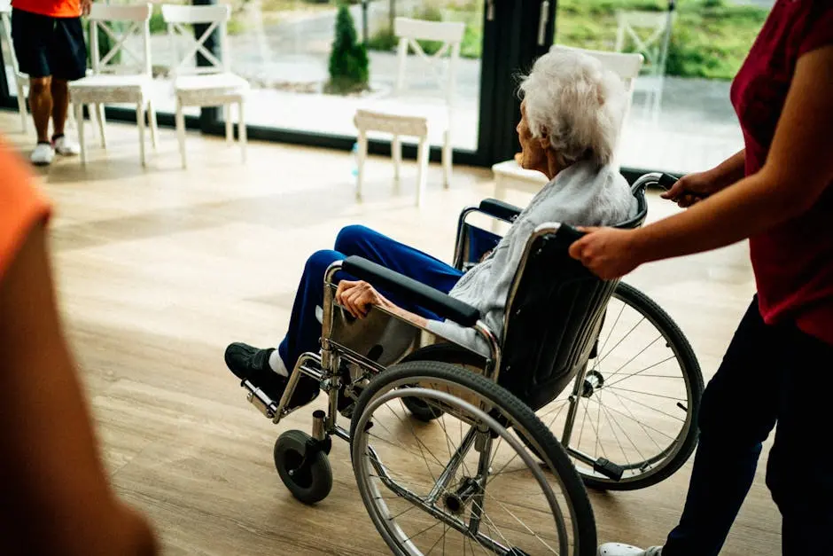 A caregiver assists a senior adult in a wheelchair at a nursing home in Prague, Czech Republic.