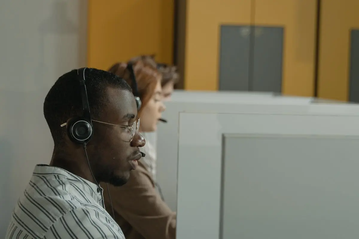 A Man in White and Black Stripe Shirt Wearing Black Headphones